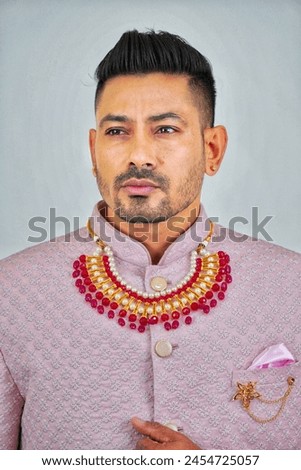 Man exudes grace and heritage in traditional attire, capturing timeless elegance and cultural pride in a single pose Royalty-Free Stock Photo #2454725057