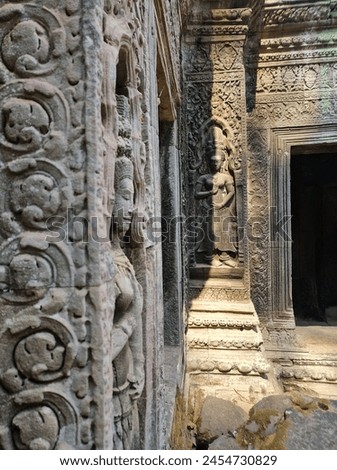 Stone carvings at Ta Prohm 'Tomb Raider' Temple in Cambodia  Royalty-Free Stock Photo #2454730829