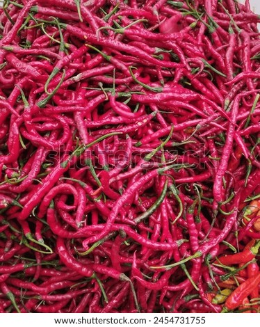 Red chili peppers can be classified as vegetables or spices, depending on how they're used. As a spice, the hot red chili peppers are very popular in Southeast Asia as a flavor enhancer for food.