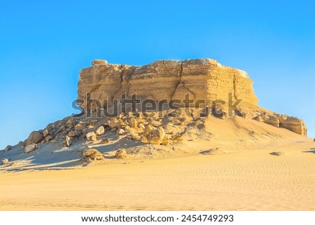 Abstract art shooting for Fayoum Rock Stone Desert, yellow sands and rocks, blue sky, photo is selective focus with shallow depth of field, Egypt