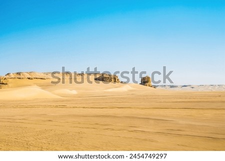 Abstract art shooting for Fayoum Rock Stone Desert, yellow sands and rocks, blue sky, photo is selective focus with shallow depth of field, Egypt