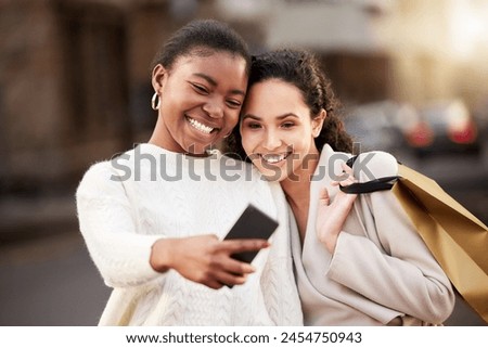 Selfie, women and smile for online shopping for memory by mall, sale or retail together outdoor by store. Happy people, paper bag and customer for photography, discount and deal for fashion.