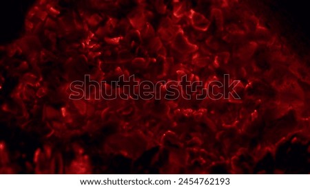 Heated coal beautifully shimmering red glow. Decaying charcoals, barbeque. Macro view. Royalty-Free Stock Photo #2454762193