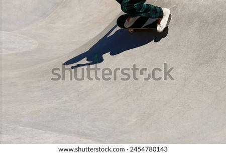 Shadow and silhouette of a skateboarder in the skate park