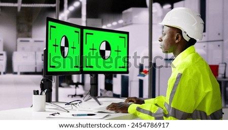 Engineer Using PC Monitor With Green Screen In Modern Factory