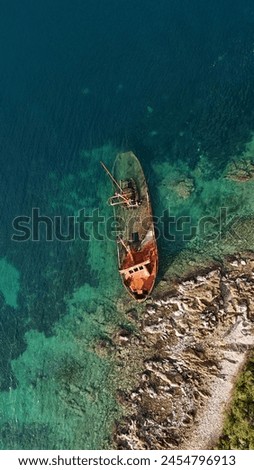 A sunken ship off the coast of the Lustica peninsula in the Bay of Kotor in the Adriatic Sea, Montenegro. View from above. Drone photo. 