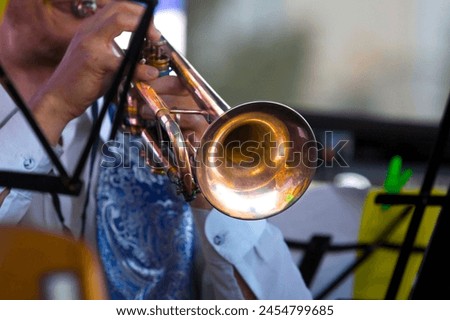 close-up of the hands of a musician playing the trumpet