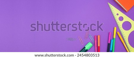 Back to school. Stationery on a Purple table. Office desk with copy space. Flat lay. Banner