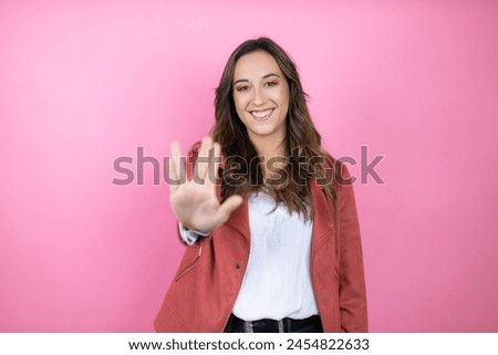 Young beautiful woman wearing casual jacket over isolated pink background doing star trek freak symbol