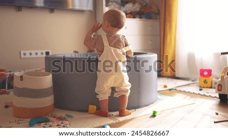 group of babies playing in room watching tv. happy family kid dream concept. baby twins indoors playing in the playroom watching tv. kindergarten learning development lifestyle concept