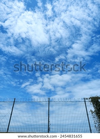 the bright blue sky with a collection of calm clouds, looks comfortable but far away and cannot be reached Royalty-Free Stock Photo #2454831655