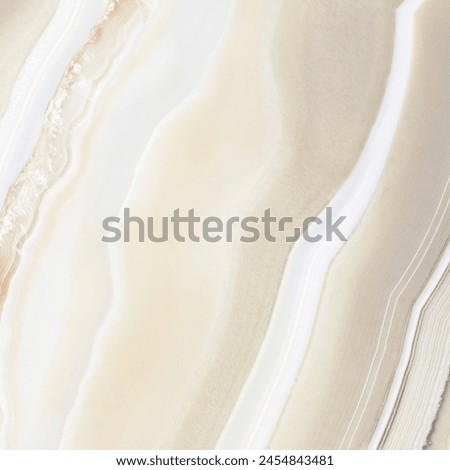 Close-up of an intricate, natural agate stone showing layered patterns in soft shades of white and beige with subtle pink accents.