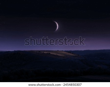 Crescent moon in the night sky with stars. Landscape with the moon over the hill.