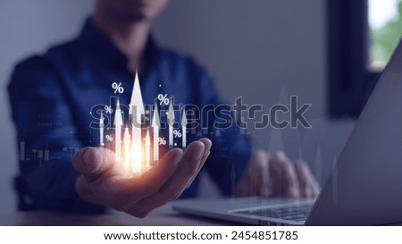 Interest rates and dividends Businessman holds arrow and percentage icon with graph indicators for investment growth. business financial investment