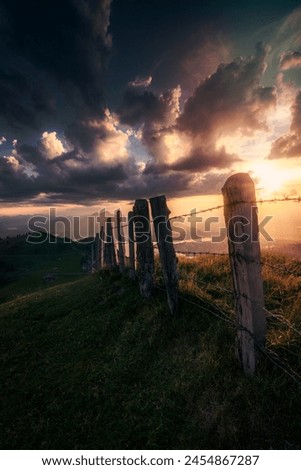 Sunset on a mountain with an old fence Royalty-Free Stock Photo #2454867287