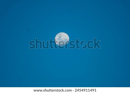 white full moon against evening blue sky in Brazil
