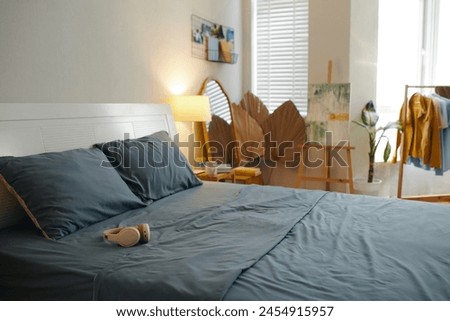 Headphones on bed in cozy bedroom