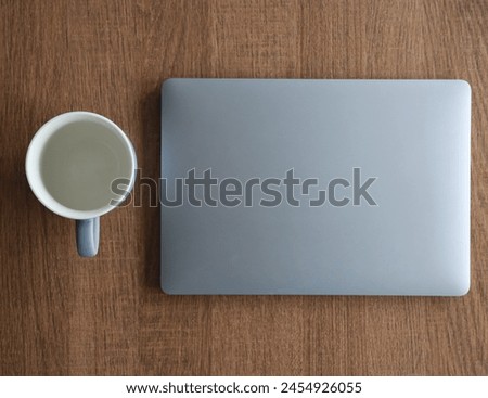 Muted colors. Laptop and cup