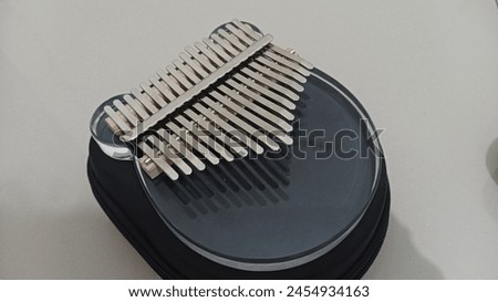 
Kalimba or mbira is an African musical instrument.Traditional to the Shona people of Zimbabwe. Kalimba made from wooden board with metal and plucking with thumbs on hands
 Royalty-Free Stock Photo #2454934163