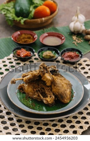 Picture of fried duck food complete with vegetables and combined with three choices of special chili sauces and seasonings