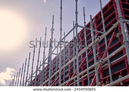 Vertical panel formwork, push-pull jacks and scaffoldings of reinforced concrete walls under construction. Structures for cast in place reinforced concrete Royalty-Free Stock Photo #2454950845