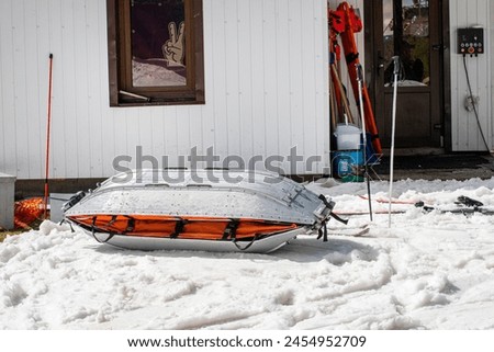 medical sled on a downhill slope for tramping downhill skiers and snowboarders. Active and safe recreation Royalty-Free Stock Photo #2454952709