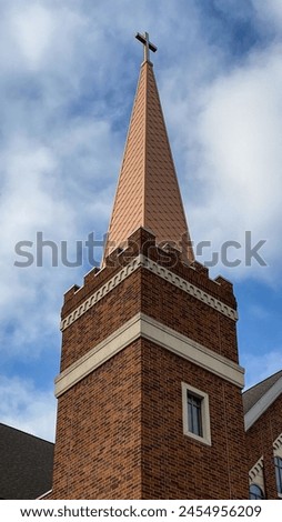 Church Steeple and Cross against Blue Sky