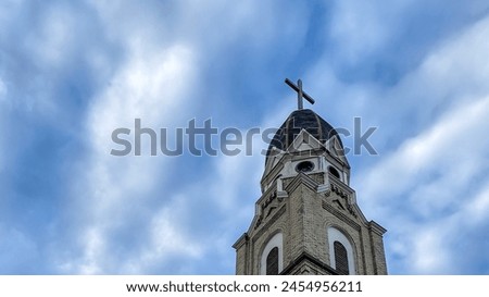 Church Steeple and Cross against Blue Sky