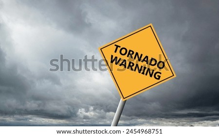 Hurricane Idalia warning sign against a powerful stormy background with copy space. Dirty and angled sign with cyclonic winds add to the drama.hurricane season sign on cloudy background Royalty-Free Stock Photo #2454968751
