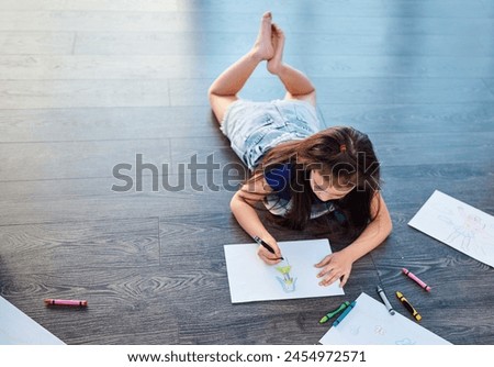 Female child, picture and drawing on ground in house with color pencil for development. Girl, playing and learning in home with crayon or paper for kindergarten, homework and homeschool education