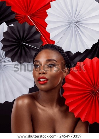 Beauty, black woman and origami fans in studio, thinking and dark background. Face, makeup and cosmetics of female model with confidence, traditional and paper art or craft for culture headwear Royalty-Free Stock Photo #2454973339
