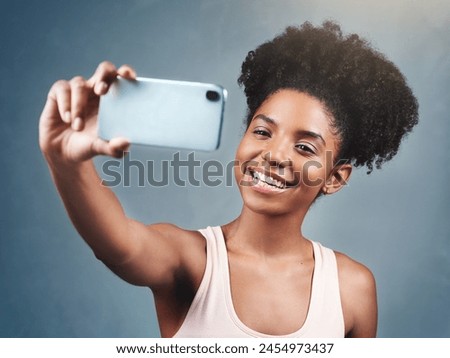 Fitness, selfie and woman in studio for wellness, streaming or profile picture photography on grey background. Training, smile and social media health influencer with exercise blog content creation