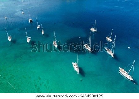 Aerial view of boats anchored in the Adriatic Sea off the coast of Croatia. The scene reveals numerous yachts moored in the open water. Ocean and sea travel and transportation concept