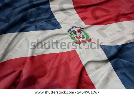waving colorful national flag of dominican republic on a euro money banknotes background. finance concept. macro shot