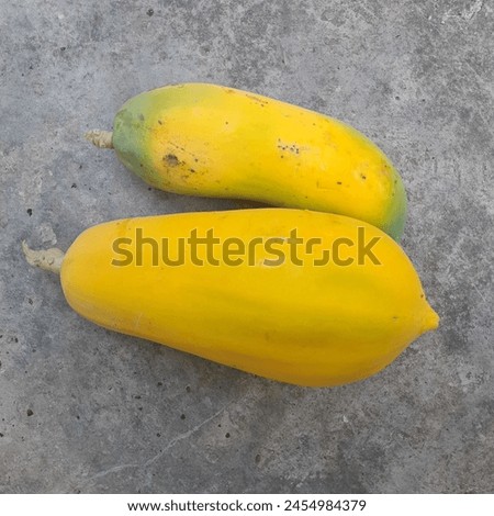 papaya, kates, pepay.this is papaya fruit. This fruit is almost ripe because it is initially green when it is unripe, but when it is ripe it will turn yellow or orange. This fruit contains many benefi Royalty-Free Stock Photo #2454984379