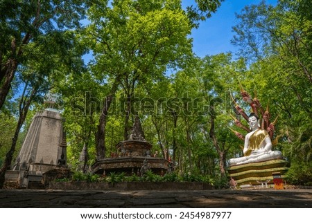 beautiful large golden Buddhist statue in peaceful jungle at Wat Analyo Thipayaram busarakam temple phayao thailand