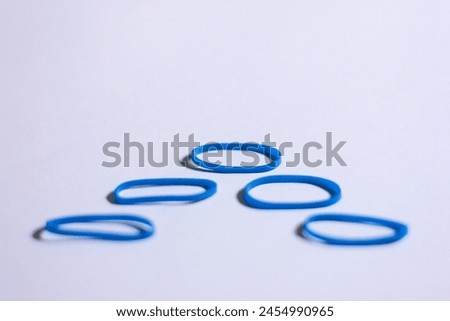 conceptual photo of blue vibrant mini rubber with defocused foreground arranged in up arrow shape look alike, hierarchy pyramid illustration concept Royalty-Free Stock Photo #2454990965