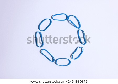 blue mini rubber bands forming a octagonal shape look alike, conceptual photoshoot illustration Royalty-Free Stock Photo #2454990973