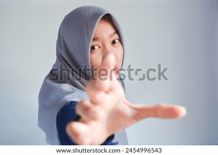A woman shows a stop gesture and refuses