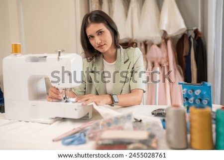 Portrait of young woman fashion designer stylish working in dressmaker studio or workshop, Fashion design concept.