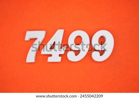 Orange felt is the background. The numbers 7499 are made from white painted wood.