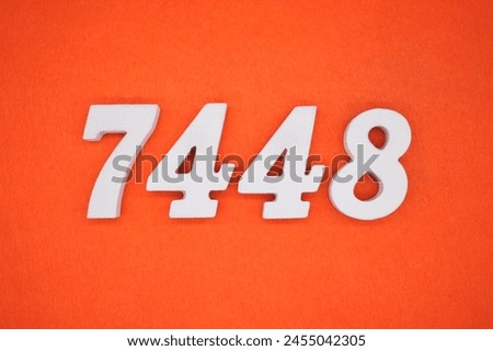 Orange felt is the background. The numbers 7448 are made from white painted wood.