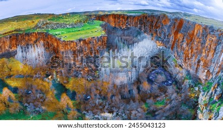 Famous and popular tourist attraction of Cappadocia and Turkey is the Ihlara Valley with a deep gorge and steep cliffs with hiking paths Royalty-Free Stock Photo #2455043123