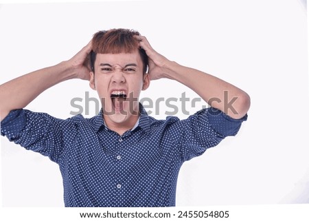 photo of young man wearing shirt,with anger. expression 
 in studio
