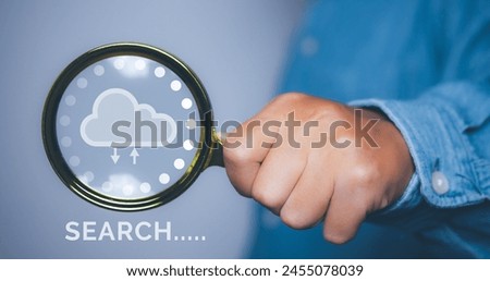 Businessman using magnifying glass search information network with cloud icon.