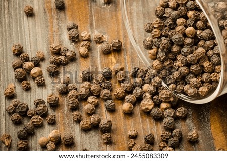 Black pepper shines in this captivating photo, adding depth and flavor to dishes worldwide. With its bold taste and aroma, it's a kitchen essential. Explore its culinary magic here!