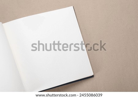 One open photo album on color background, top view. Space for text