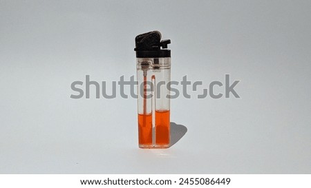 
The red lighter is standing on a plain white background.