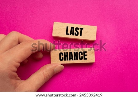 Last chance words written on wooden blocks with pink background. Conceptual last chance symbol. Copy space.