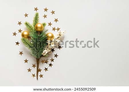 new year background with christmas tree, golden toys and star confetti on a light white background. Festive xmas decoration gold stars confetti. Empty space for copy space. flat lay, top view